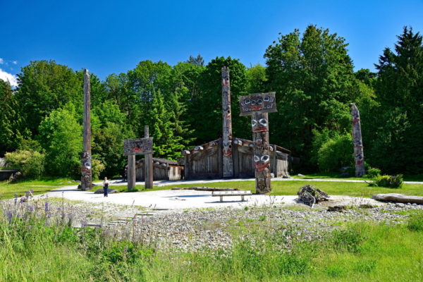 British Columbia totem poles in a field